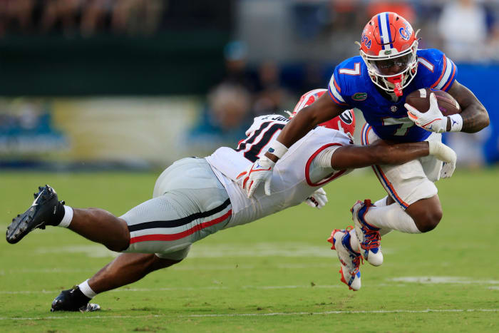 Trevor Etienne (7) is tackled by Jamon Dumas-Johnson (10). Etienne is now at Georgia, while Dumas-Johnson is now a Kentucky Wildcat.